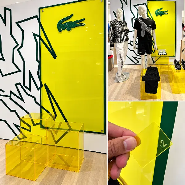 Painéis em acrílico amarelo com grafismo preto em loja da Lacoste